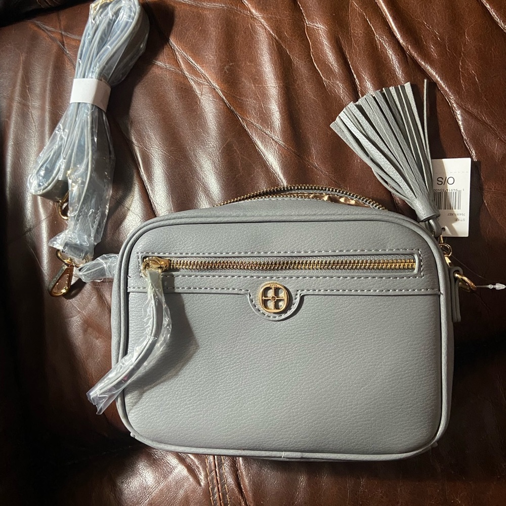 Crossbody each includes a wristlet and removable tassel